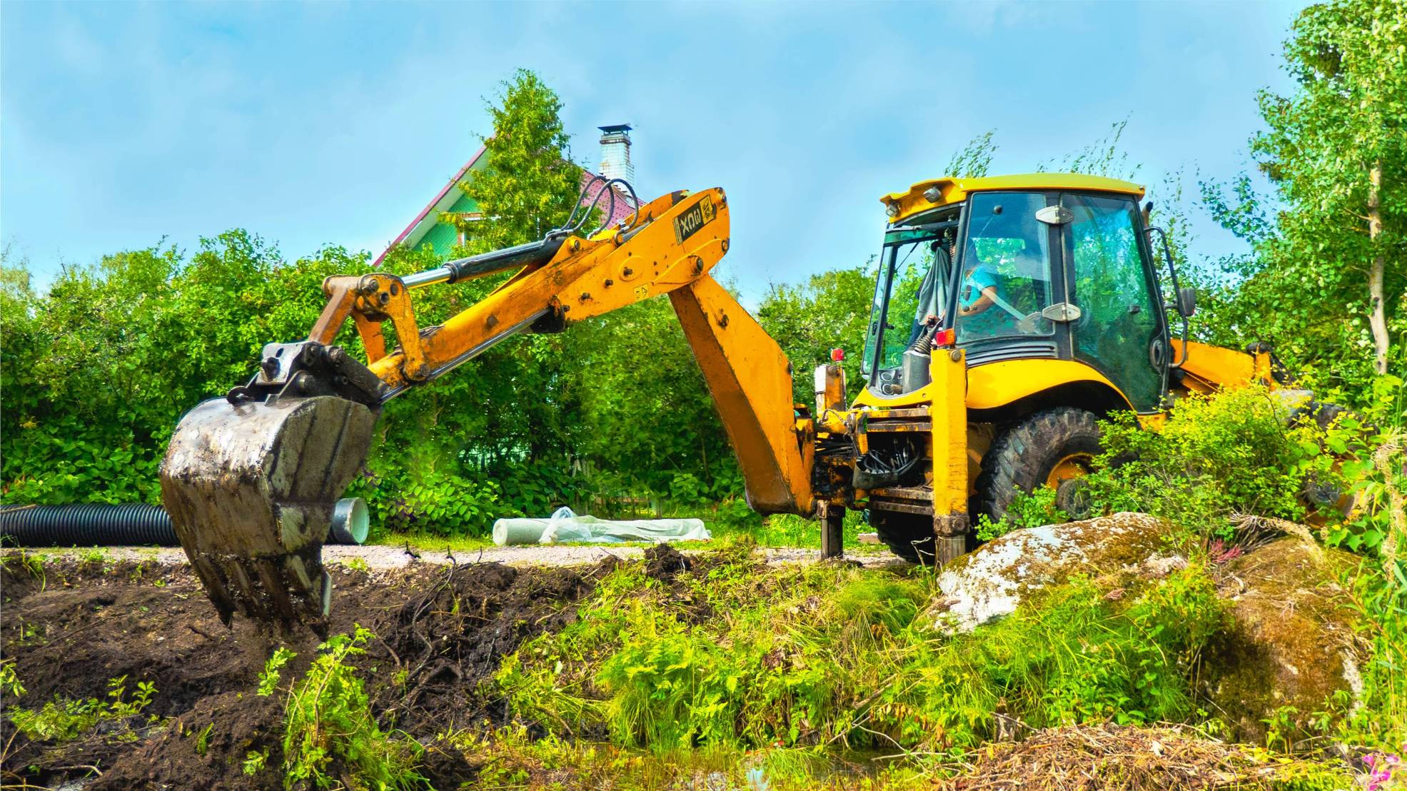 excavator-with-bucket-in-the-field-among-a-grass-2025-01-09-06-10-10-utc